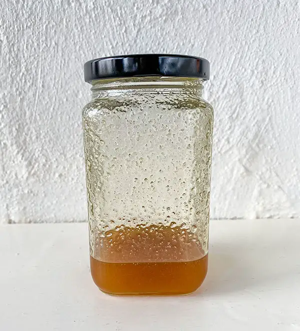 Half full jar of runny honey