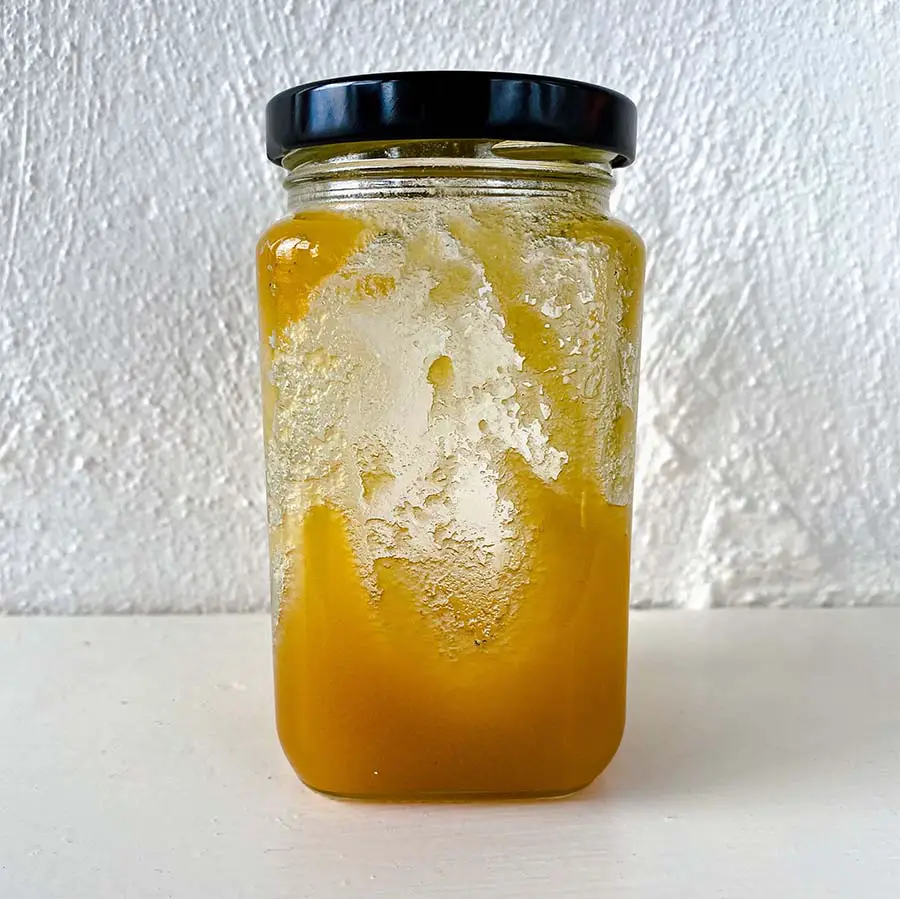 Half full jar of crystalized honey