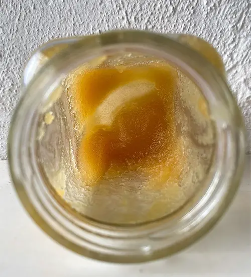 The inside of a jar of crystalized honey