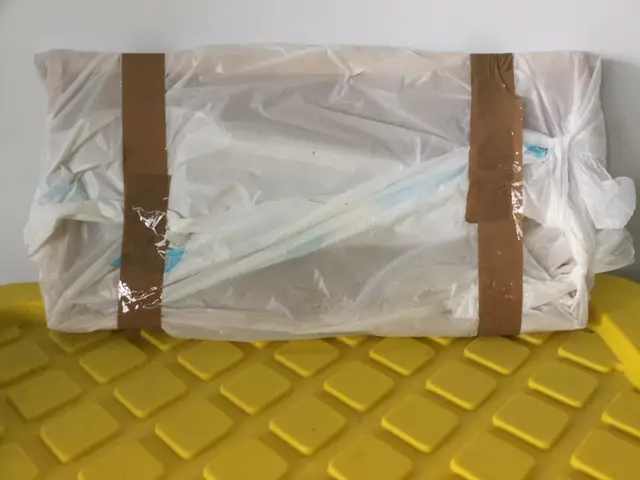 Close up of frames inside a plastic bag, placed on top of a plastic tub