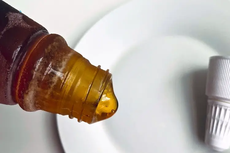 Frozen honey slowly oozing from an open squeeze bottle