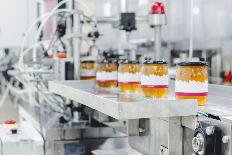 Assembly line showing honey being pasteurized in a factory